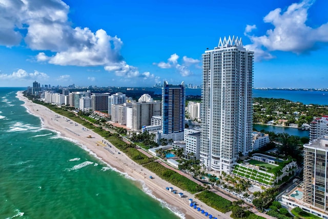 birds eye view of property with a water view and a view of the beach