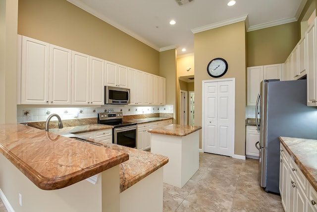 kitchen featuring a center island, light stone counters, kitchen peninsula, a towering ceiling, and appliances with stainless steel finishes