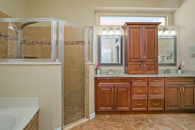 bathroom with tile patterned floors, vanity, and separate shower and tub