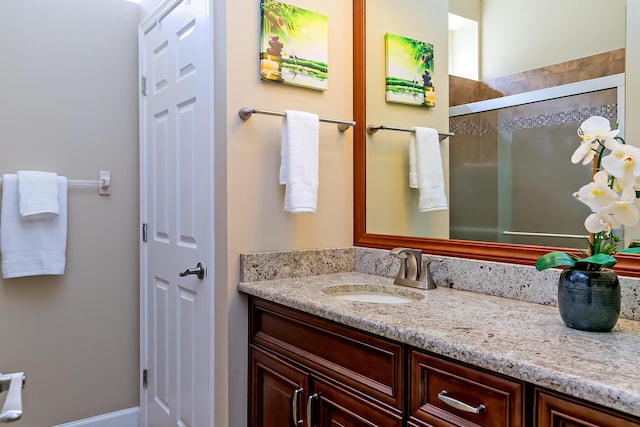 bathroom featuring vanity and an enclosed shower