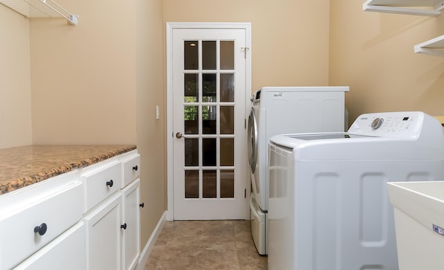 washroom featuring washer and clothes dryer, cabinets, and sink