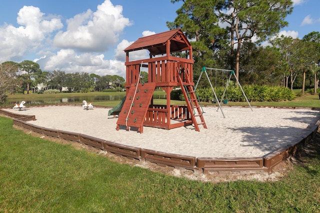 view of jungle gym with a yard and a water view