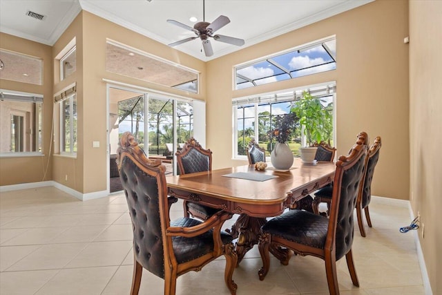 tiled dining area featuring ceiling fan and ornamental molding