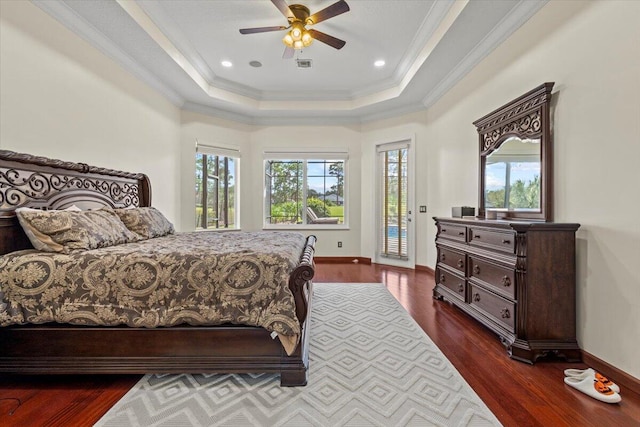 bedroom featuring dark wood-type flooring, crown molding, ceiling fan, access to exterior, and a tray ceiling