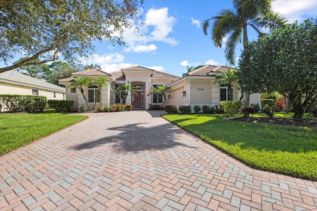 mediterranean / spanish-style house featuring a front lawn