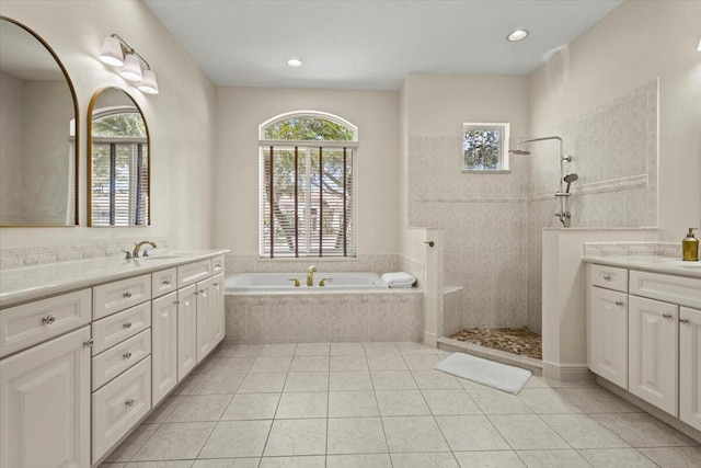 bathroom with tile patterned flooring, vanity, and independent shower and bath