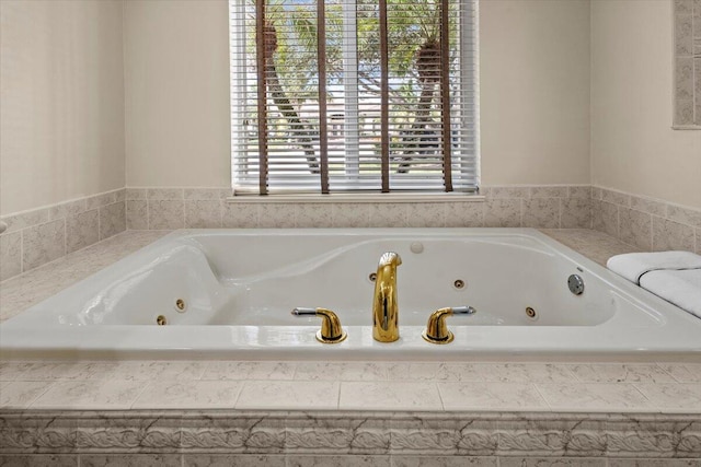 bathroom featuring tiled tub