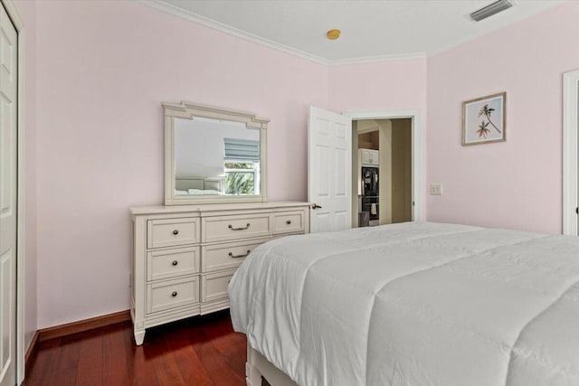 bedroom featuring crown molding and dark hardwood / wood-style floors