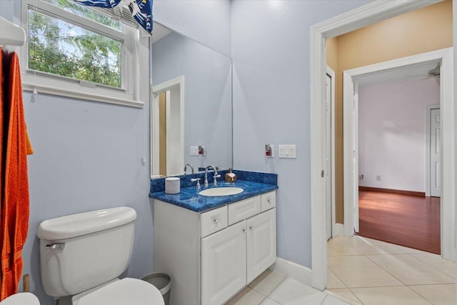 bathroom featuring tile patterned flooring, vanity, and toilet