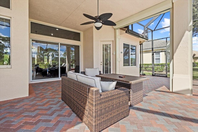 view of patio / terrace with an outdoor hangout area, ceiling fan, and a lanai