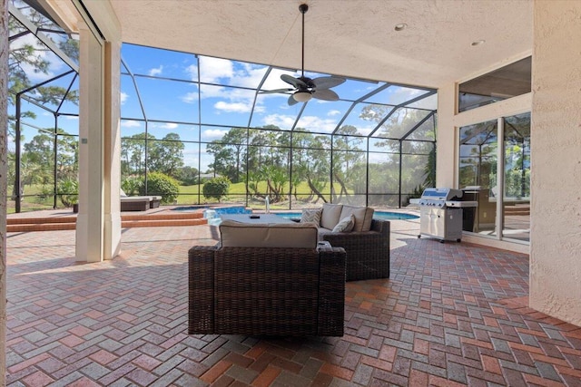 view of patio featuring a pool with hot tub, a grill, a lanai, and ceiling fan