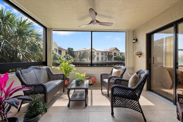 sunroom featuring ceiling fan