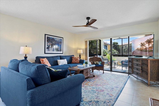 tiled living room with ceiling fan and a textured ceiling