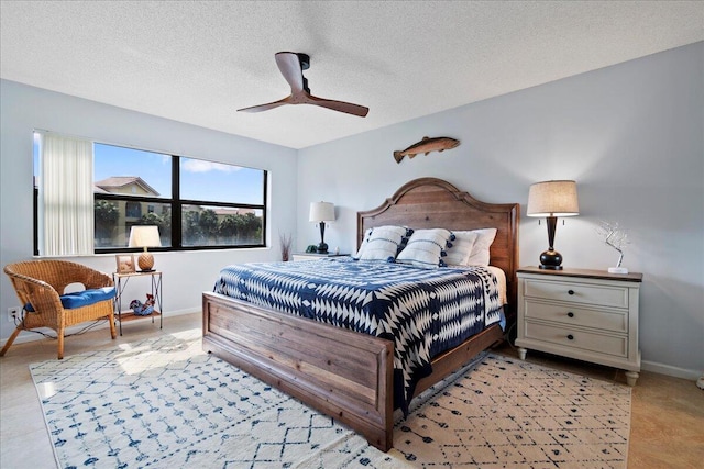 bedroom with ceiling fan and a textured ceiling