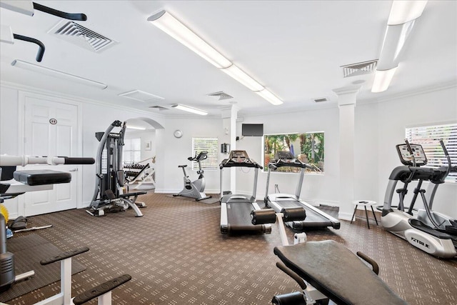 gym featuring ornamental molding and ornate columns