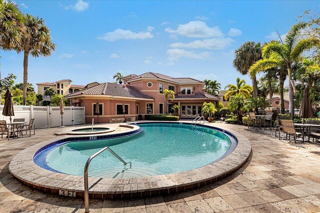 view of pool with a community hot tub and a patio area