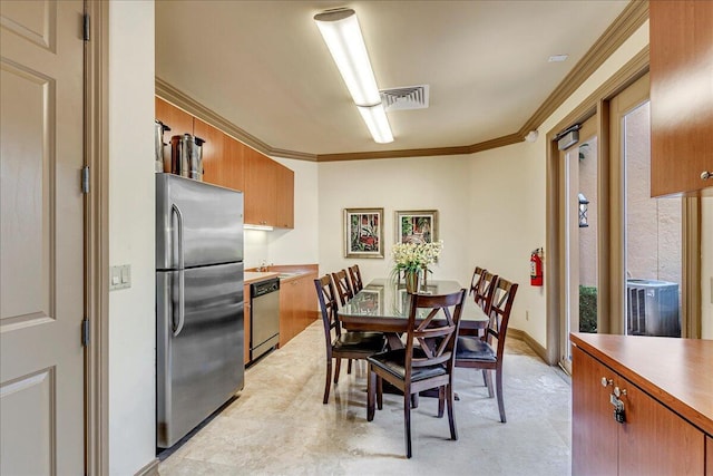 dining space featuring crown molding and sink