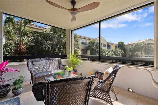 sunroom featuring ceiling fan