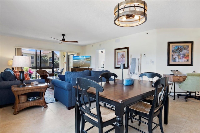 dining space with ceiling fan, light tile patterned floors, and a textured ceiling