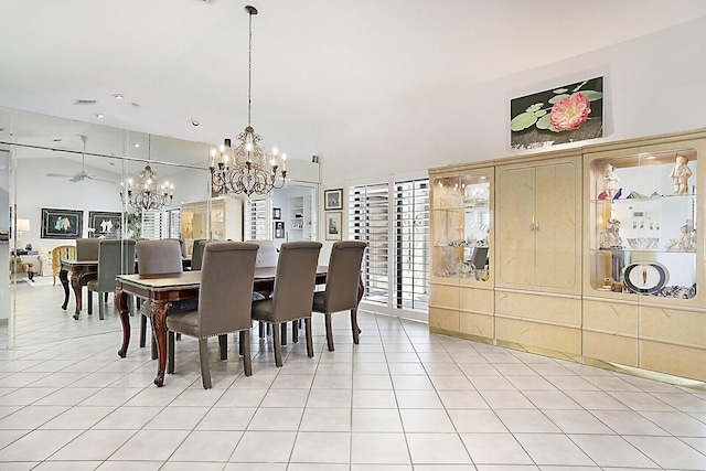 dining area featuring lofted ceiling, light tile patterned floors, visible vents, and a notable chandelier