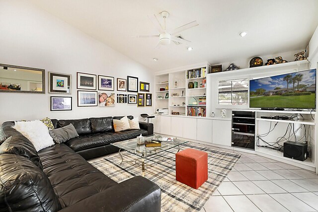 living room featuring ceiling fan, light tile patterned flooring, built in features, and vaulted ceiling