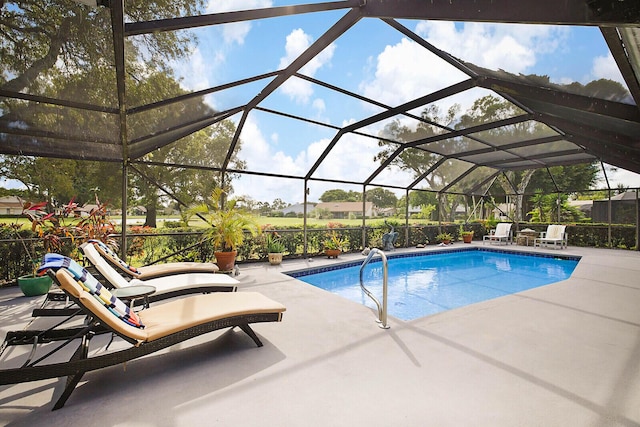 pool featuring a patio and glass enclosure