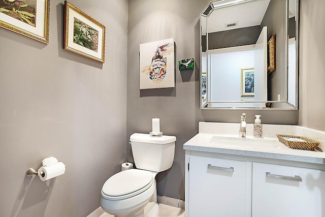 bathroom featuring visible vents, vanity, and toilet