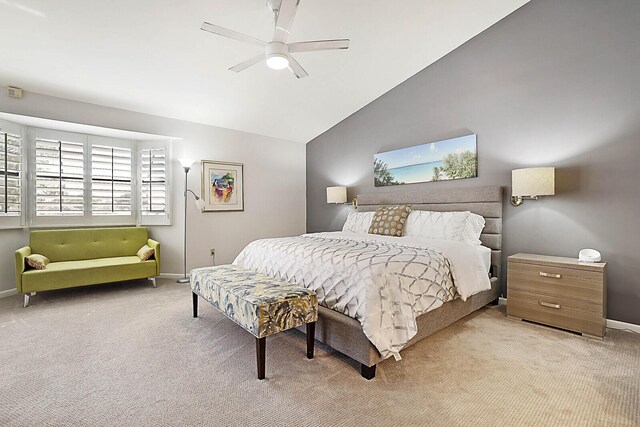 bedroom with ceiling fan, light carpet, and vaulted ceiling