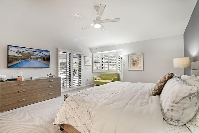 carpeted bedroom featuring ceiling fan, lofted ceiling, and access to exterior