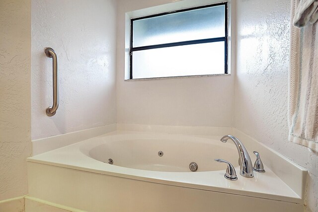 bathroom featuring a tub to relax in