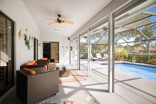 view of swimming pool with glass enclosure and a patio