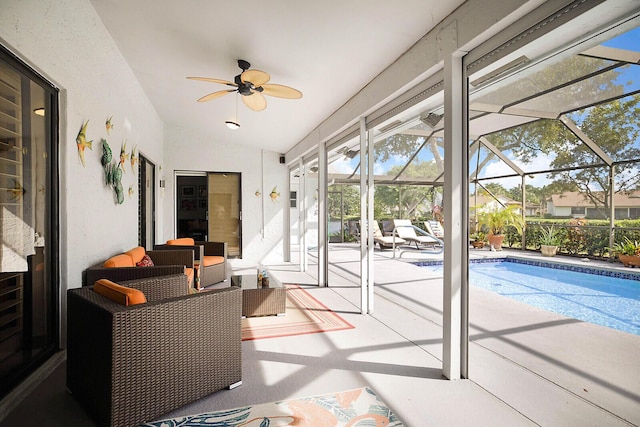 sunroom / solarium featuring lofted ceiling and ceiling fan