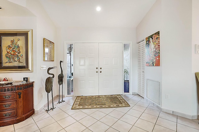 entryway featuring baseboards, visible vents, and light tile patterned flooring