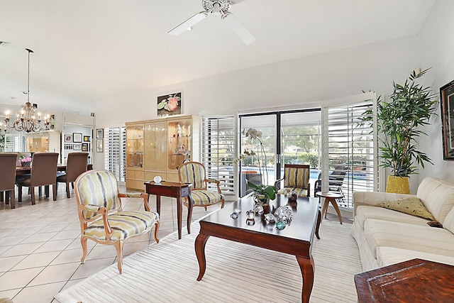 tiled living room featuring ceiling fan with notable chandelier