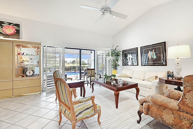 living area featuring light tile patterned floors, ceiling fan, and high vaulted ceiling