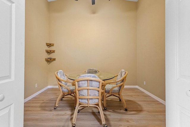 dining area featuring light wood-style flooring and baseboards