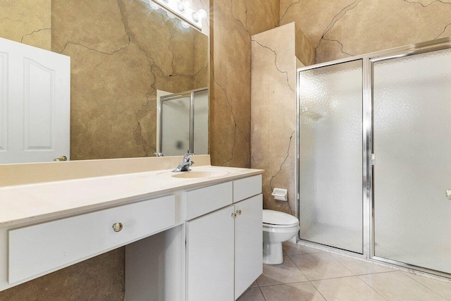 full bathroom with tile patterned flooring, toilet, a shower stall, and vanity