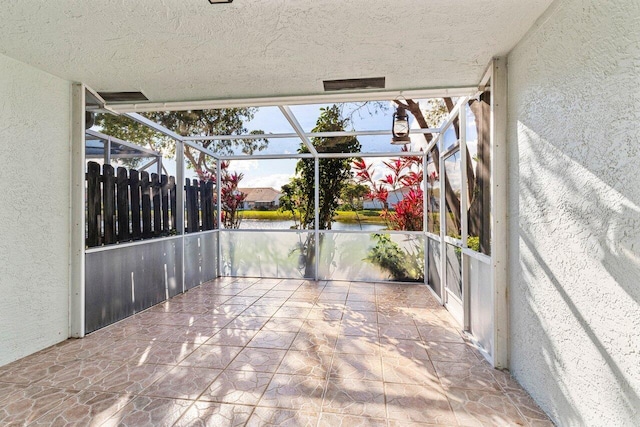 view of patio / terrace featuring glass enclosure