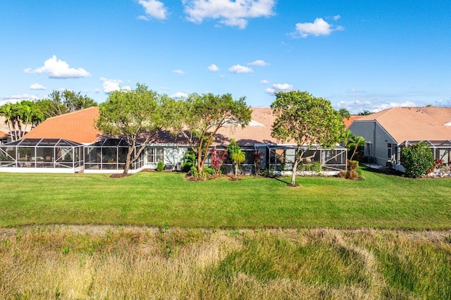 view of yard with glass enclosure