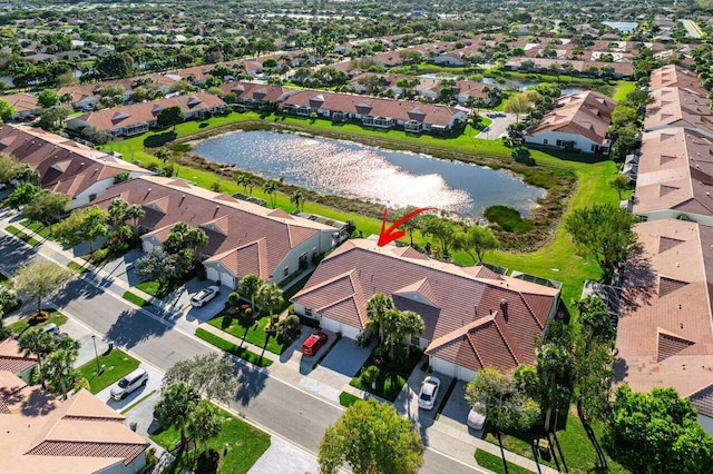 birds eye view of property with a water view and a residential view