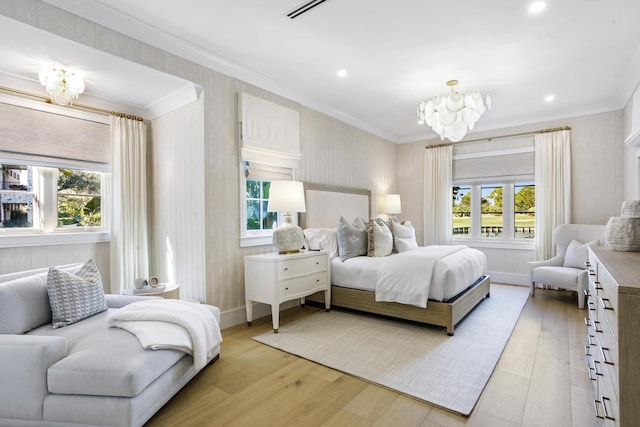 bedroom featuring light wood-type flooring, crown molding, multiple windows, and a notable chandelier