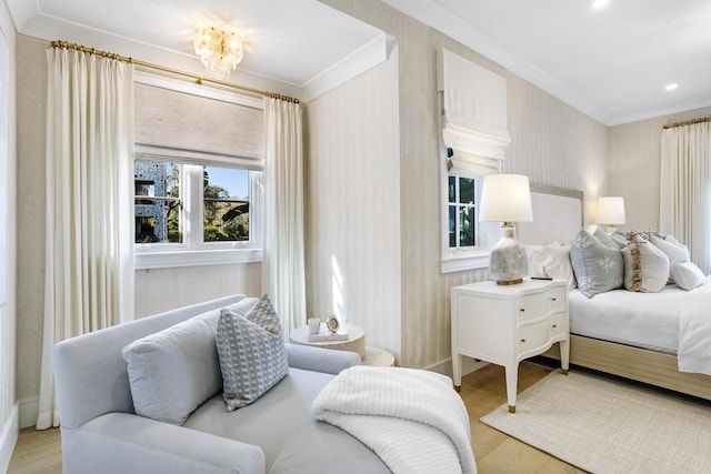 bedroom featuring crown molding and light hardwood / wood-style flooring