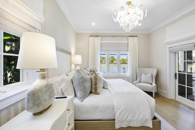 bedroom featuring light hardwood / wood-style flooring, crown molding, and a notable chandelier