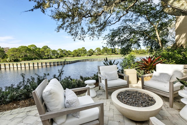 view of patio / terrace featuring a fire pit and a water view