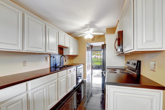 kitchen with white cabinetry, appliances with stainless steel finishes, sink, and ceiling fan