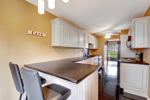 kitchen with white cabinetry, ceiling fan, and kitchen peninsula