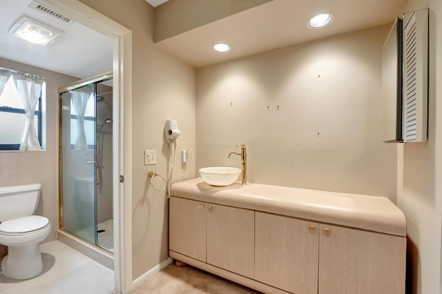 bathroom with sink, a shower with shower door, and toilet