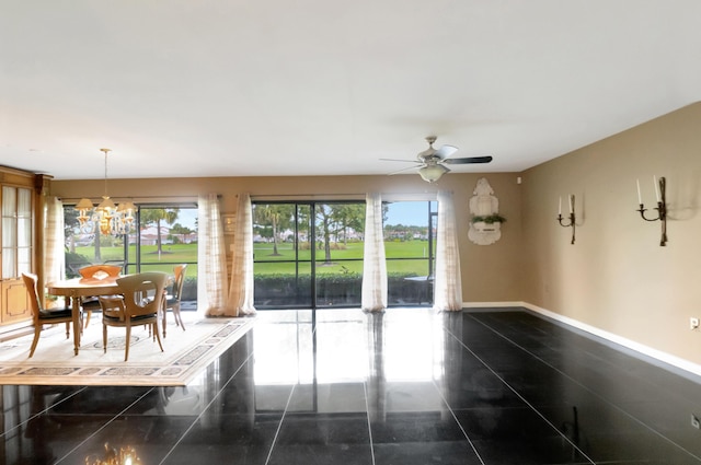 interior space with ceiling fan with notable chandelier