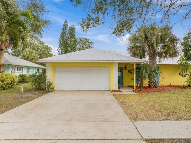 single story home with a garage and a front yard