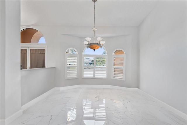 empty room with an inviting chandelier